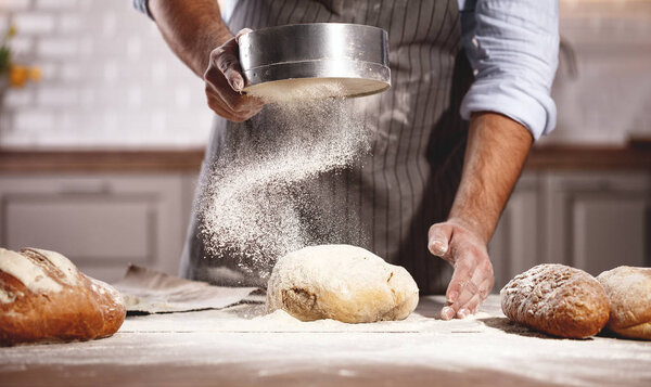 hands of baker 's male knead tough
