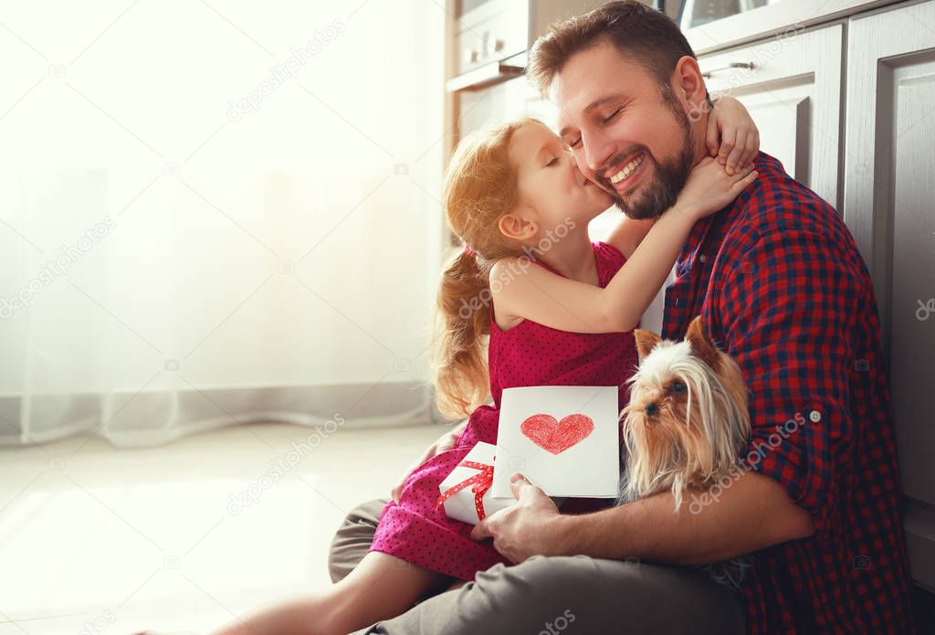 Father's day. Happy family daughter giving dad greeting card