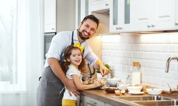 Happy family in kitchen. Father and child daughter knead dough a — Stock Photo, Image