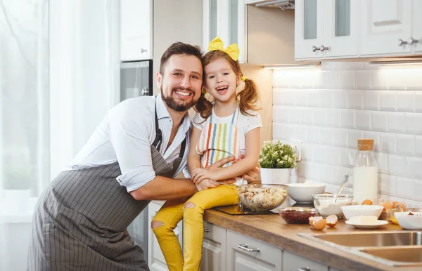 Happy family in kitchen. Father and child daughter knead dough a — Stock Photo, Image