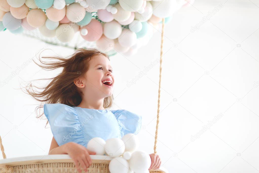 charming child girl in a fairy magic hot air balloon