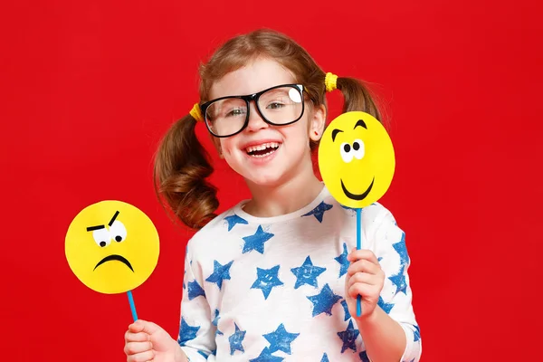 Concept of children's emotions. child girl chooses between a sad — Stock Photo, Image