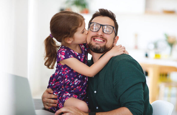 Father's day. Happy family daughter hugs his dad  
