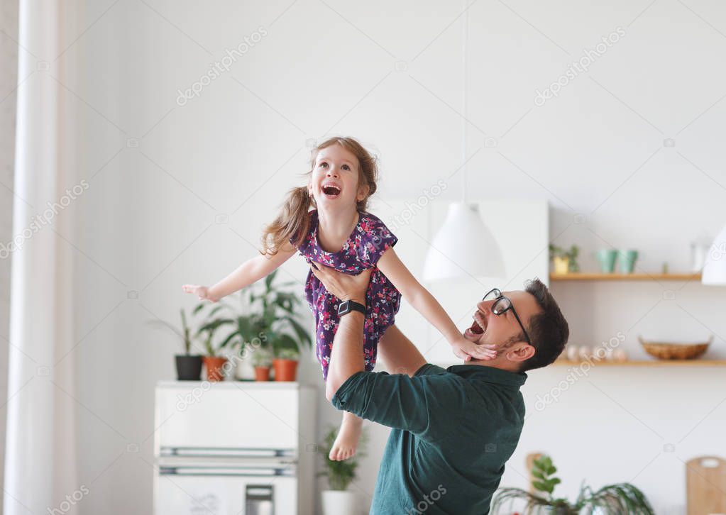 Father's day. Happy family daughter hugs his dad  