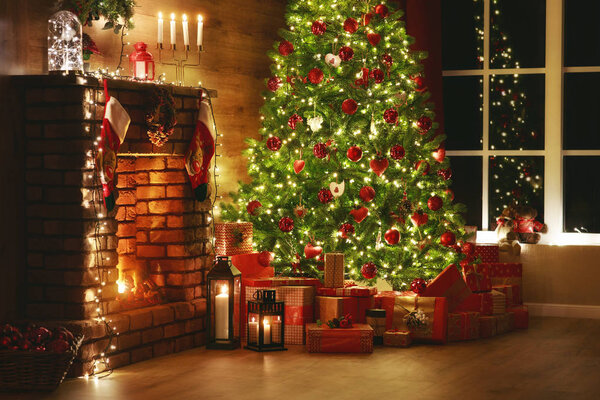 interior christmas. magic glowing tree, fireplace, gifts in  dar
