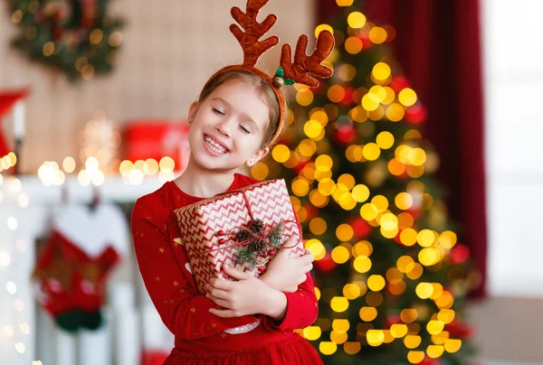 Heureux rire enfant fille avec Noël présent à hom — Photo