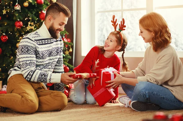 Lycklig familj med gåvor nära julgran på hom — Stockfoto