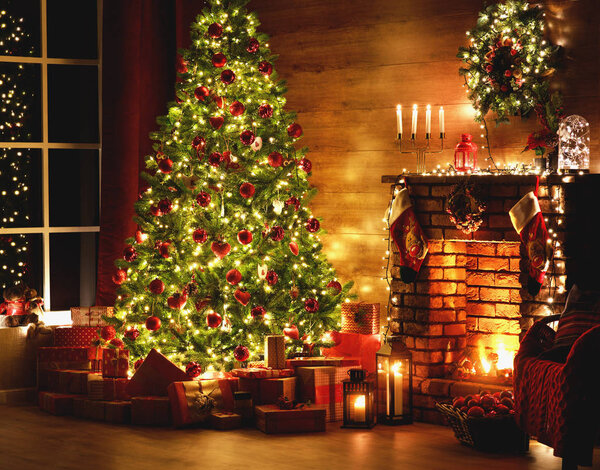 interior christmas. magic glowing tree, fireplace, gifts in  dar