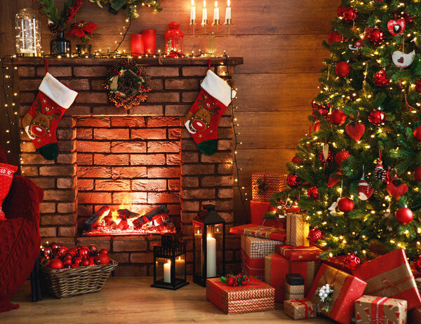 interior christmas. magic glowing tree, fireplace, gifts in  dar