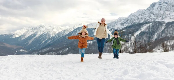 Happy family mother and children having fun on winter wal — Stock Photo, Image
