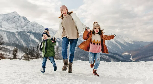 Happy family mother and children having fun on winter wal — Stock Photo, Image