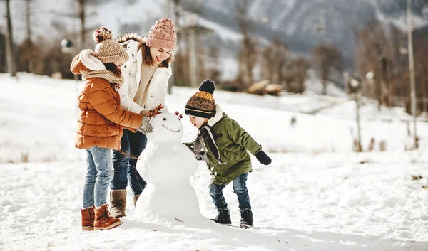 Happy family mother and children having fun on winter walk — Stock Photo, Image