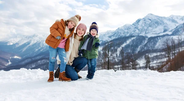 Happy family mother and children having fun on winter walk — Stock Photo, Image