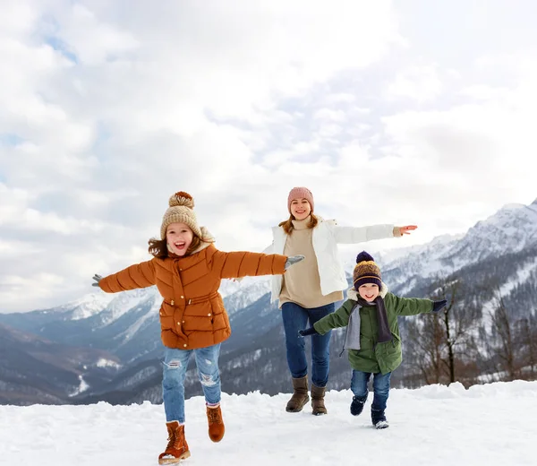 Happy family mother and children having fun on winter walk — Stock Photo, Image
