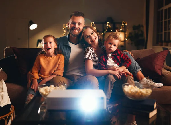 Family mother father and children watching projector, TV, movies — Stock Photo, Image