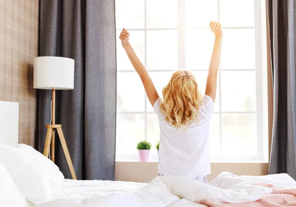 Χαριτωμένο κορίτσι ξυπνάει στο δωμάτιό της και τεντώνεται το πρωί — Φωτογραφία Αρχείου
