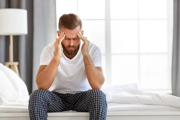Young  man with a headache, was sick in bed in   bedroo — Stock Photo, Image