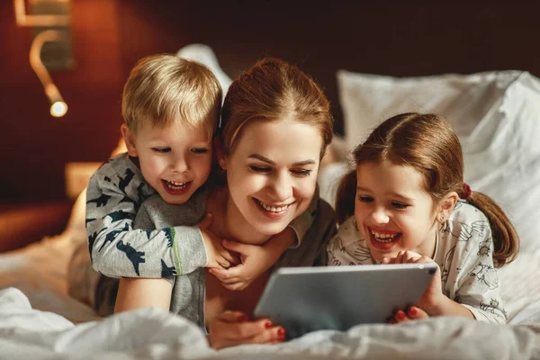 Mãe família feliz e crianças com computador tablet em casa em — Fotografia de Stock