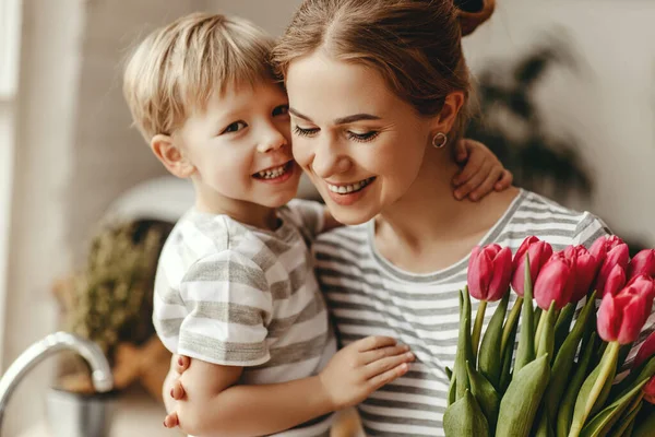 Gelukkige Moederdag! kind zoon geeft bloemen voor moeder op holid — Stockfoto
