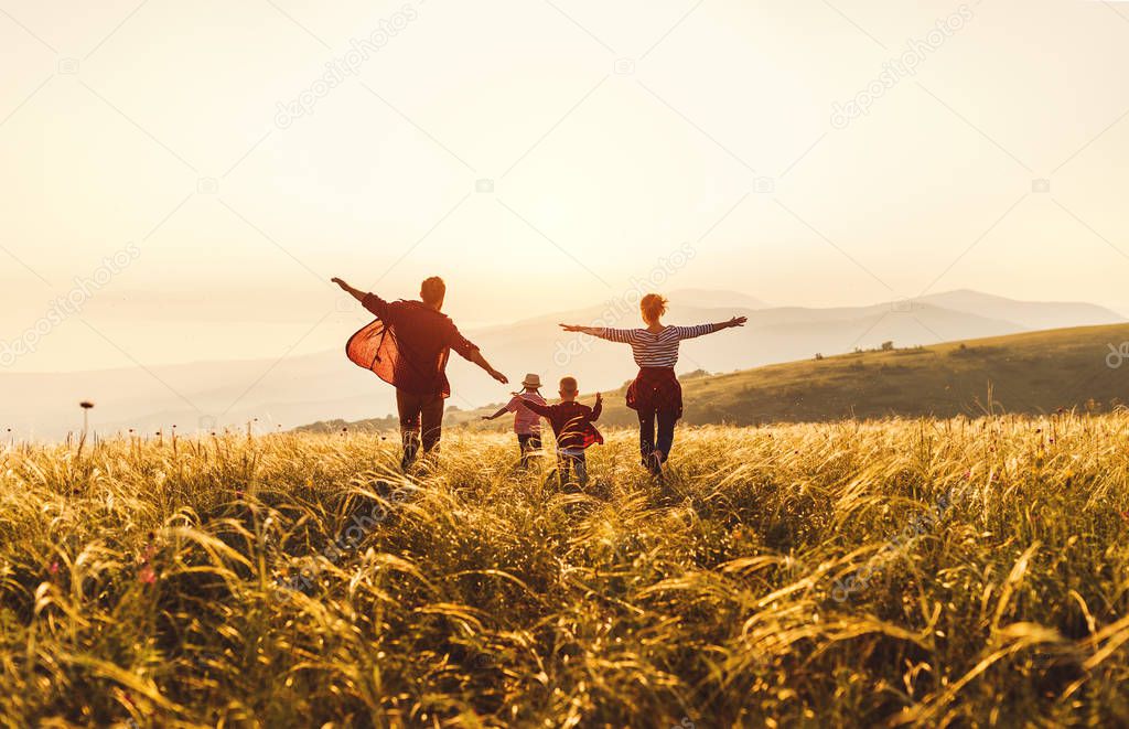 Happy family: mother, father, children son and daughter runing a