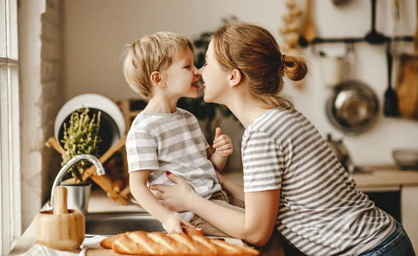 Preparation of family breakfast. mother and child son cut bread — 스톡 사진