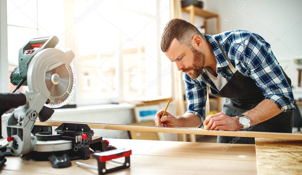 young male carpenter working in a worksho