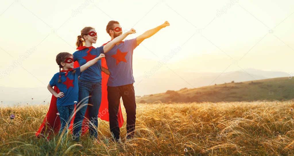 concept of super family, family of superheroes at sunset in natur