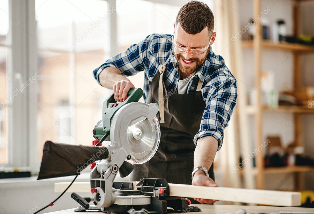 young male carpenter working in a worksho