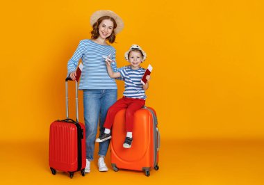 İyi yolculuklar! Gezginler ailesi çantalı anne ve çocuk. Biletler ve pasaportlar renkli sarı arka grupta.