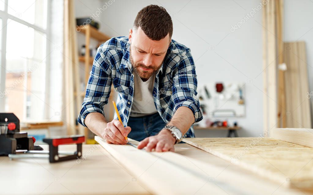 young male carpenter    working in a worksho