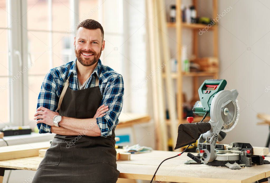 young male carpenter    working in a worksho