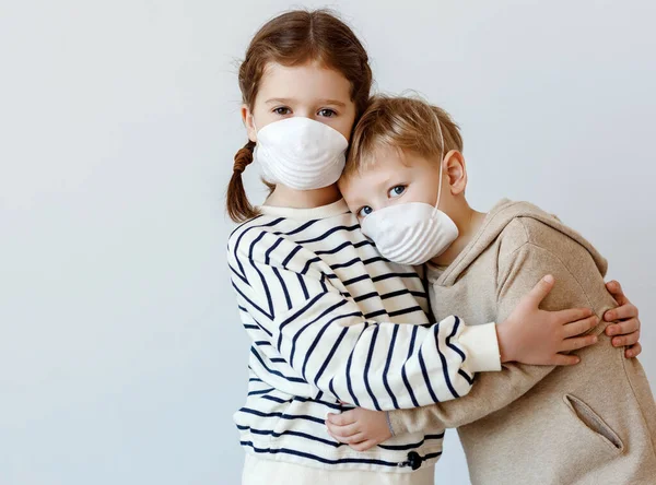 Little Girl Hugging Supporting Brother Medical Mask While Standing Gray — Stock Photo, Image