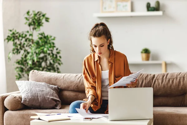 Calm Focused Female Freelancer Casual Clothes Revising Reports While Sitting — Stock Photo, Image