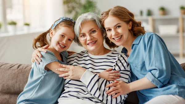 Elderly Female Hugging Little Girl Young Woman Smiling Looking Camera — Stock Photo, Image