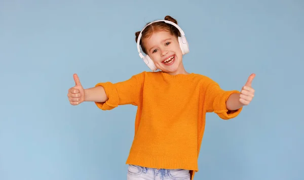 Cheerful Little Girl Casual Clothes Headphones Smiling Camera Showing Thumb — Stock Photo, Image