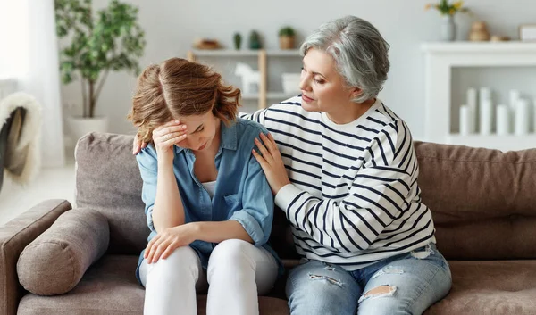 Elderly Woman Embracing Supporting Crying Young Daughter While Sitting Couch — Stock Photo, Image