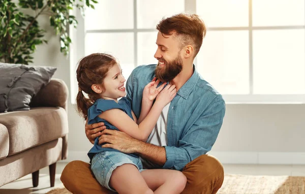 Cheerful Young Man Hugging Little Daughter While Sitting Together Floor — Stock Photo, Image