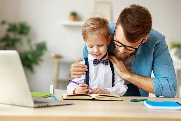 Young Bearded Man Eyeglasses Helping Smiling Little Boy Homework While — Stock Photo, Image