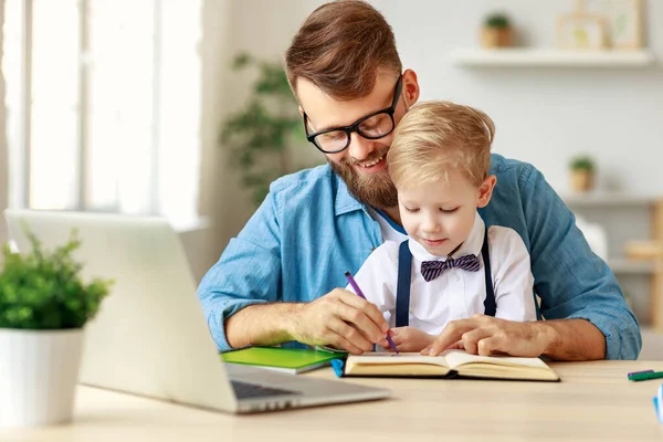 Young Bearded Man Eyeglasses Helping Smiling Little Boy Homework While — Stock Photo, Image