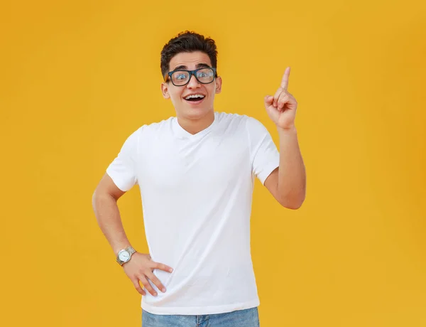 Delighted Ethnic Guy Hands Waist Smiling Pointing Yellow Backdro — Stock Photo, Image