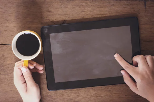 woman drinking an arabic coffee and using tablet