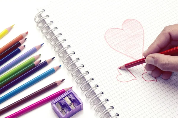 heart hand drawing on notebook and pencil for valentine\'s day