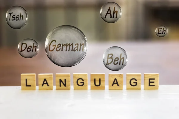 language wooden letters and german flying bubbles,learning english concept