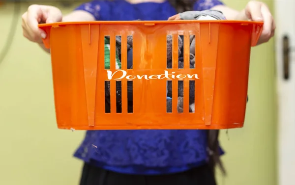 Closeup Women Holding Clothes Plastic Orange Box Donation — Stock Photo, Image