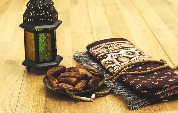 Dates, Oriental Lamp, prayer mat Ramadan Kareem Greeting Card. Ramadan Mubarak. Translated: Happy & Holy Ramadan. Month of fasting for Muslims.
