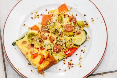 dilimler halinde, sebze sosis ile lezzetli omlet bölümünü kesip