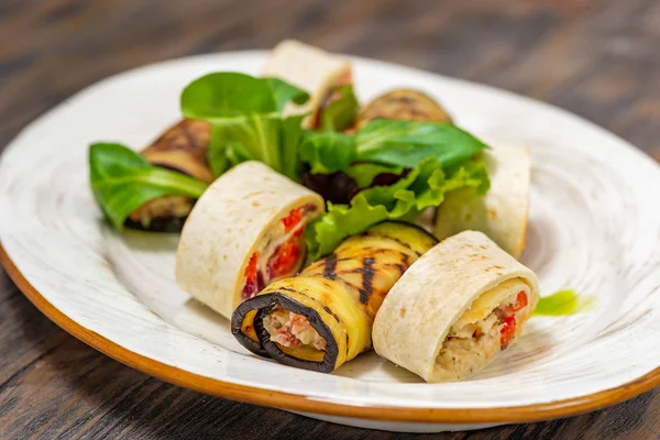 Rolls with fish and eggplant rolls with herbs on a plate — Stock Photo, Image
