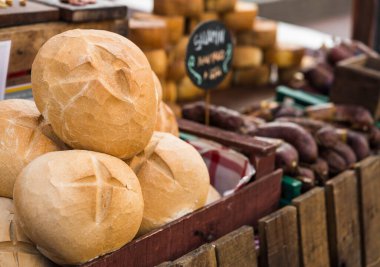 Bread and Italian delicatessen cold meats and cheese at a street food market.