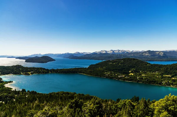 Landscape of blue lakes, Andes mountains, and forest in Patagonia, Argentina.