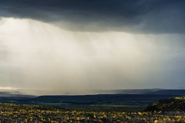 Background of rain, dark clouds, steppes, and mountains in Patagonia, Argentina. — Stock Photo, Image
